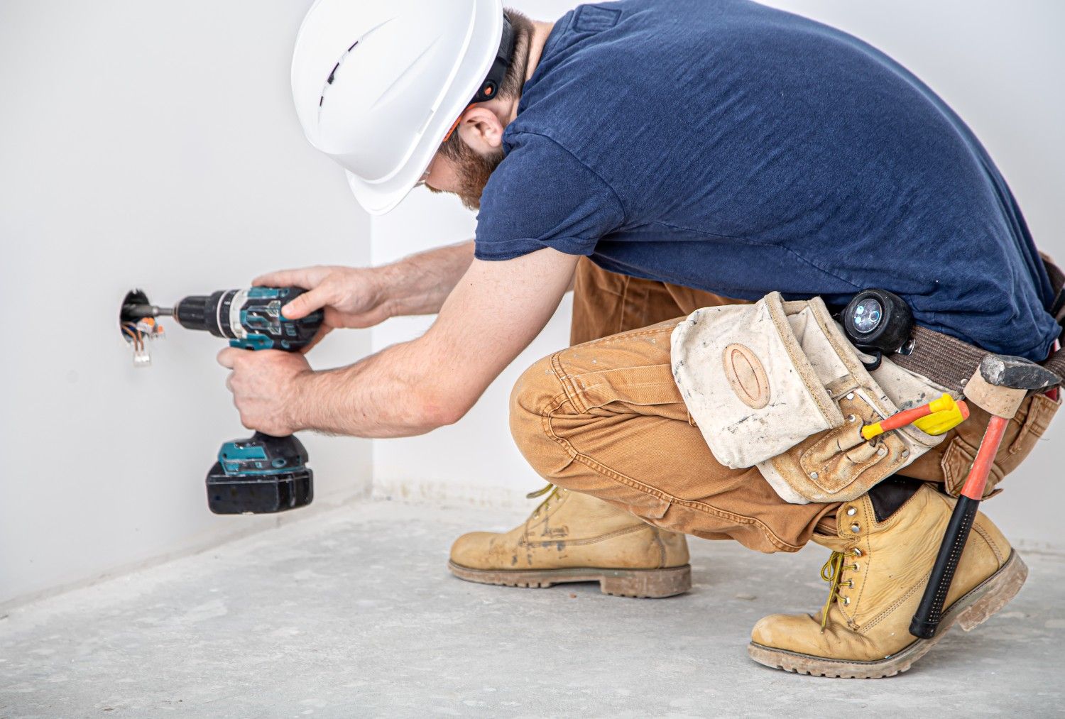 electrician builder work installation lamps height professional overalls with drill background repair site concept working as professional 1